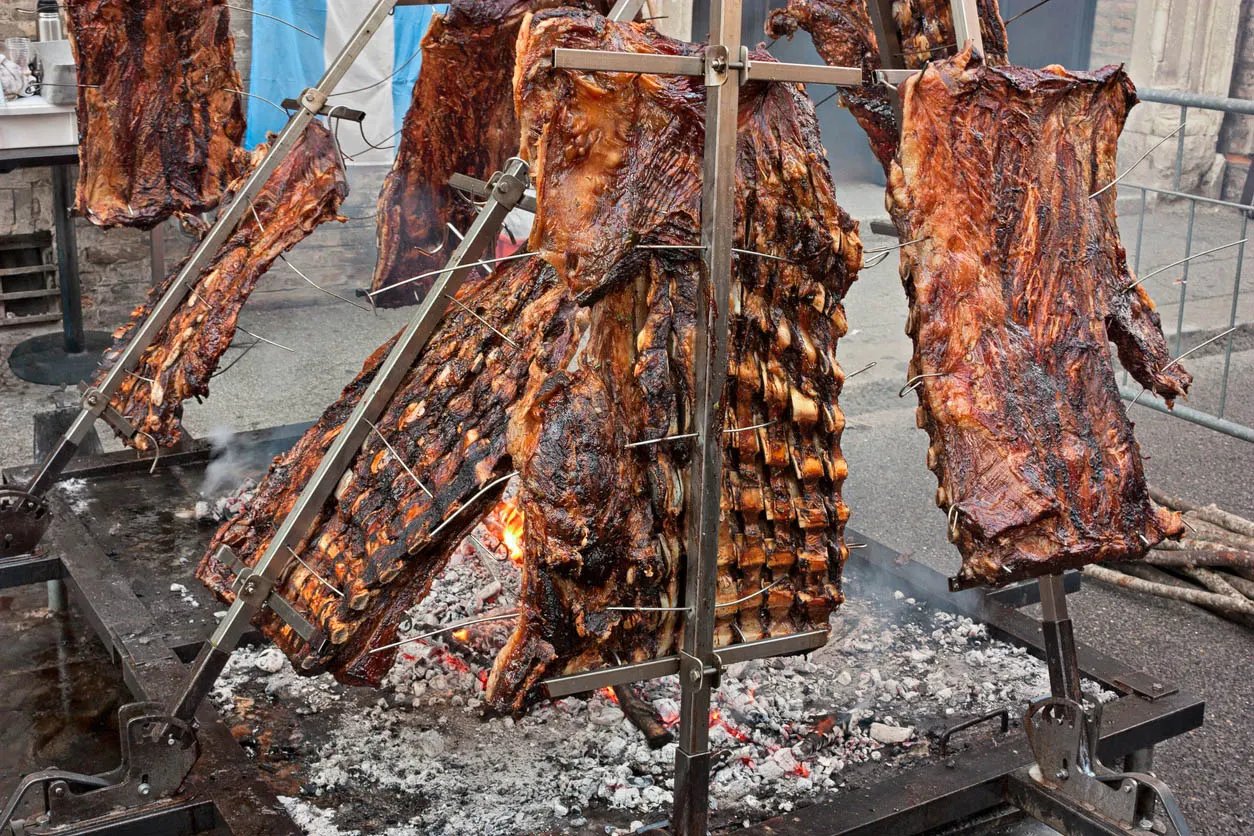 Person Cooking on Live Fire Asado Event